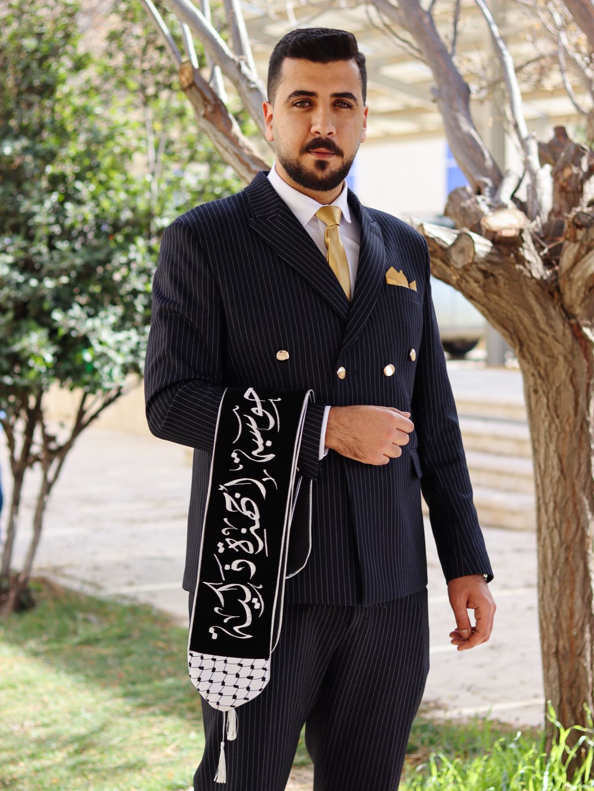 Formal portrait against greenery