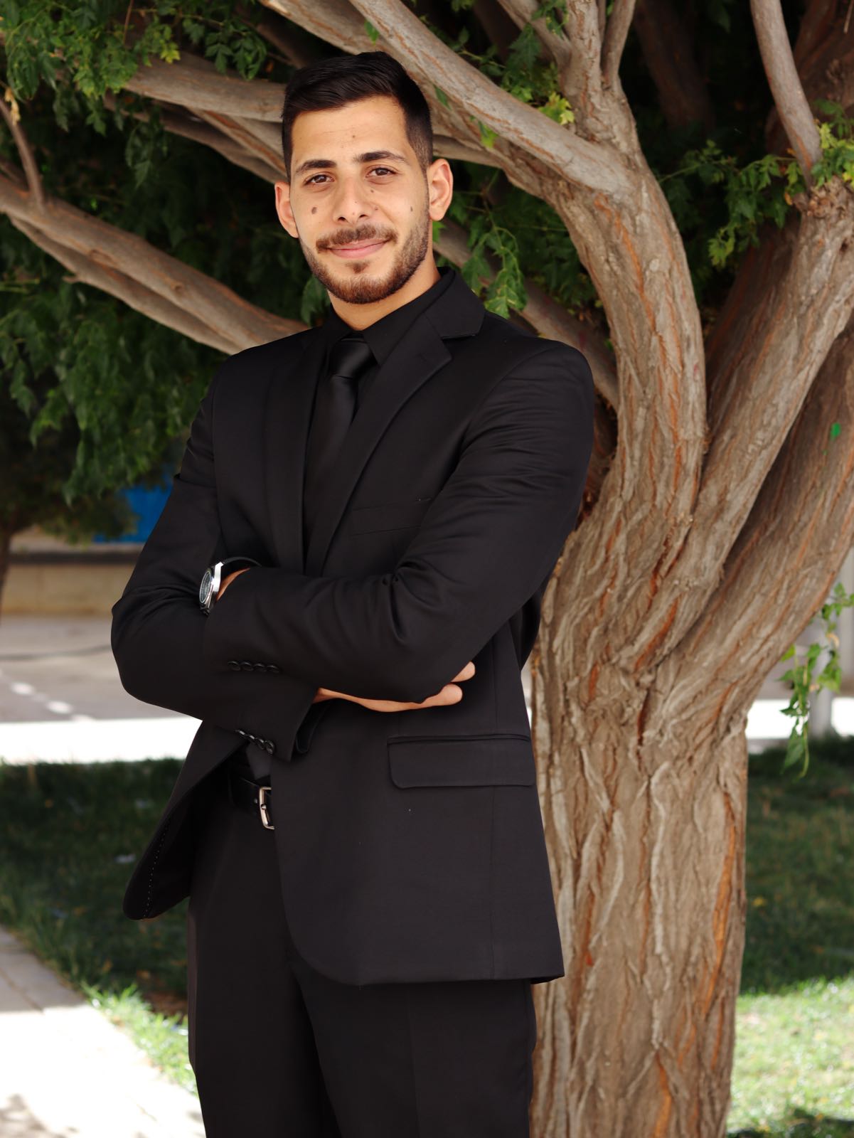Portrait under tree, black suit