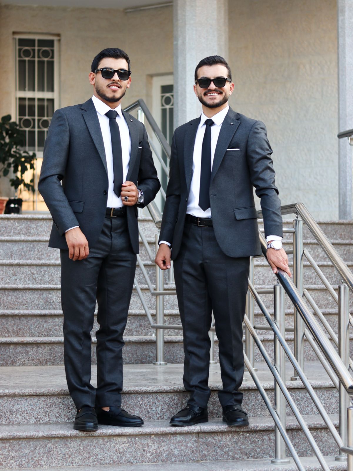 Graduation portrait in navy suit outdoors