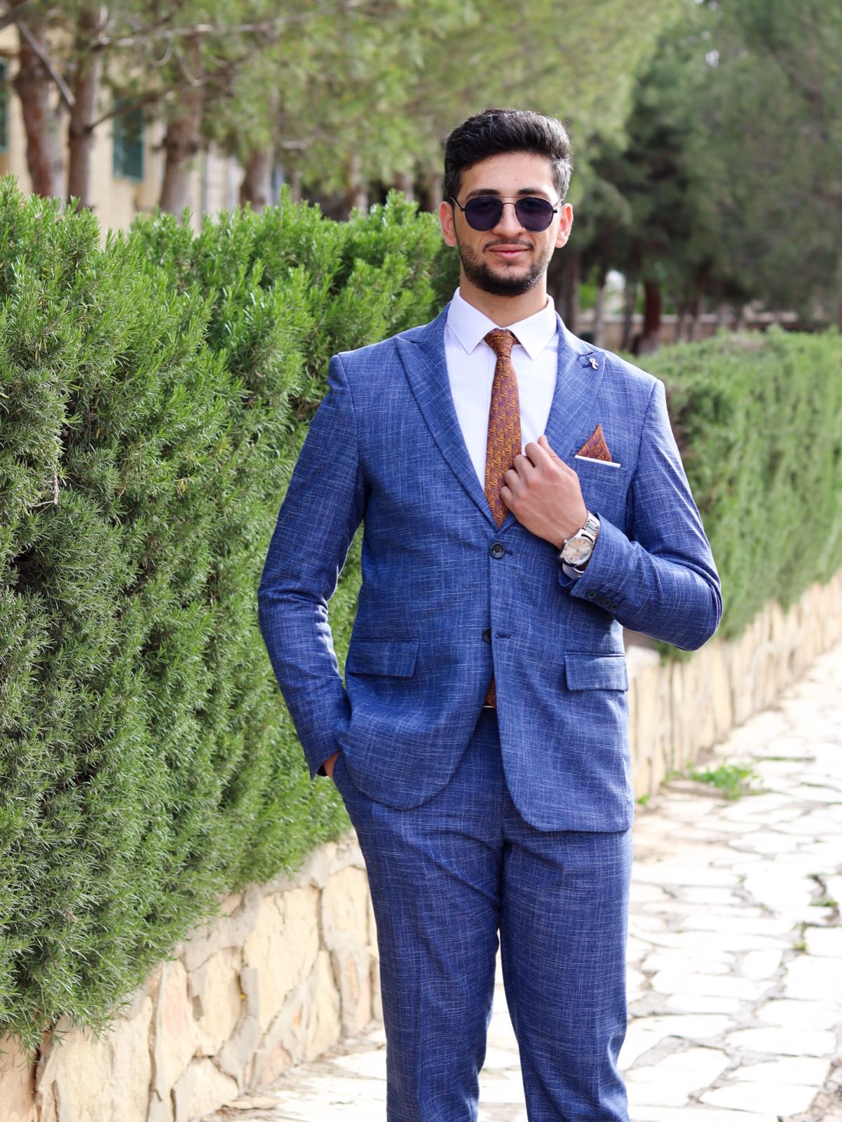 Portrait, blue suit, hedges